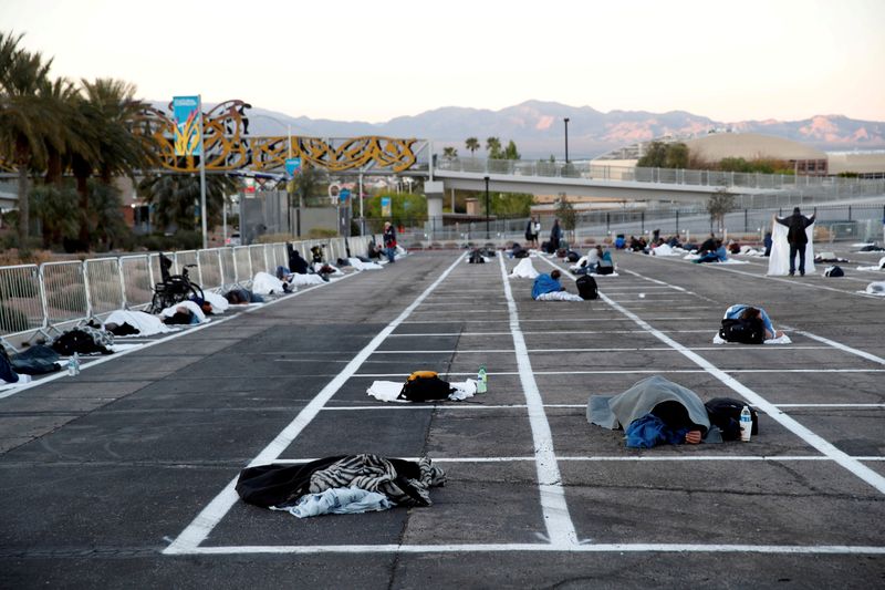 FILE PHOTO: Homeless people sleep in a parking lot with spaces marked for social distancing in Las Vegas