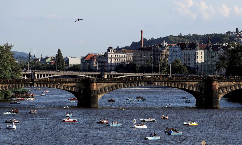 FILE PHOTO: People ride pedal boats on the Vltava river in Prague