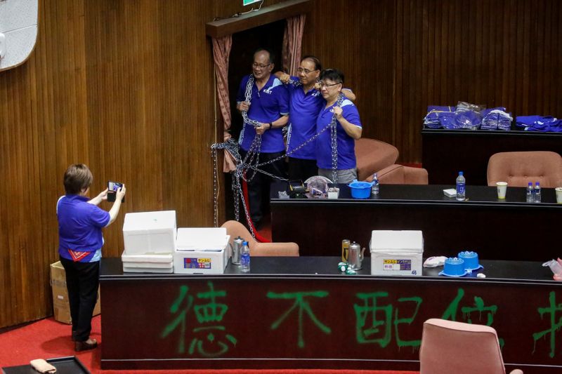 Lawmakers, part of a group consisting of more than 20 from Taiwan's main opposition party the Kuomintang (KMT), pose for a picture while occupying the Legislature Yuan in Taipei, Taiwan