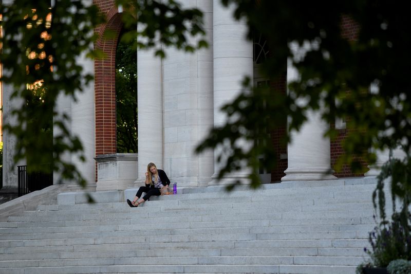 FILE PHOTO: Hannah Carlile, a masters student, relaxes on the steps of the Faye and Joe Wyatt Center for Education on the campus of Peabody College at Vanderbilt University
