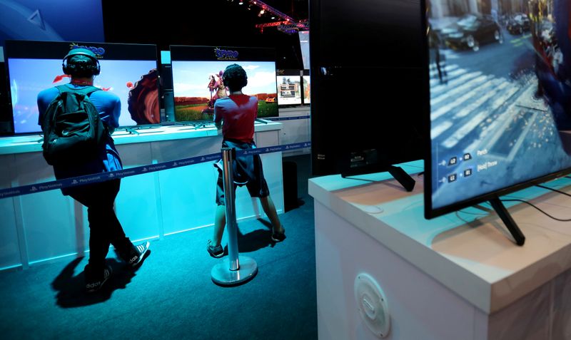 FILE PHOTO: People play a game during the Game XP 2018 at the Olympic Park in Rio de Janeiro, Brazil