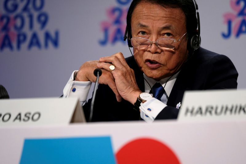 Japanese Finance Minister Taro Aso takes questions from reporters at the annual meetings of the International Monetary Fund and World Bank in Washington