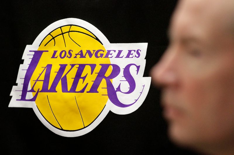 FILE PHOTO: The Los Angeles Lakers logo is pictured past the profile of Lakers spokesman John Black during a news briefing regarding the death of longtime Lakers owner Jerry Buss, at the Lakers' practice facility in El Segundo