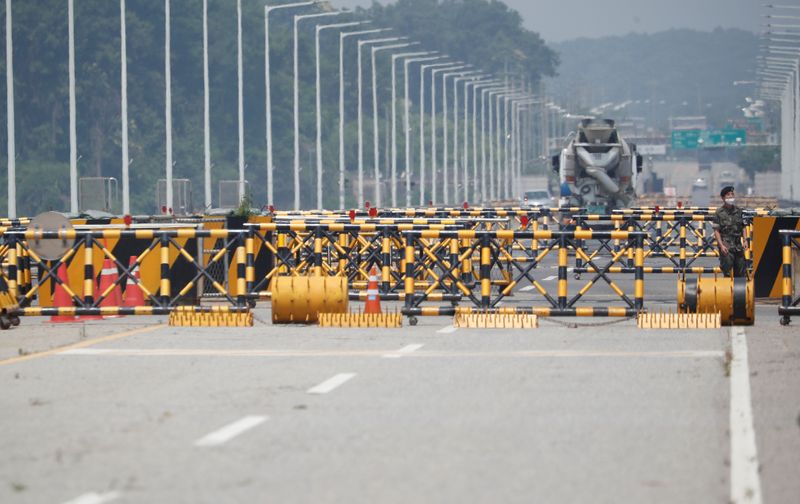 FILE PHOTO: A soldier stands guard at a checkpoint on the Grand Unification Bridge which leads to the inter-Korean Kaesong Industrial Complex in North Korea, just south of the demilitarized zone separating the two Koreas, in Paju