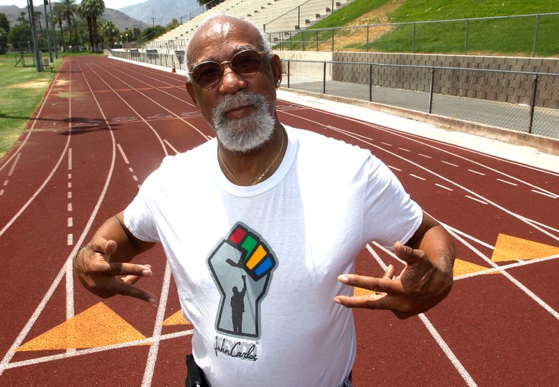 FILE PHOTO: John Carlos, participant of the 1968 Olympics, stands on the campus track at Palm Springs High School