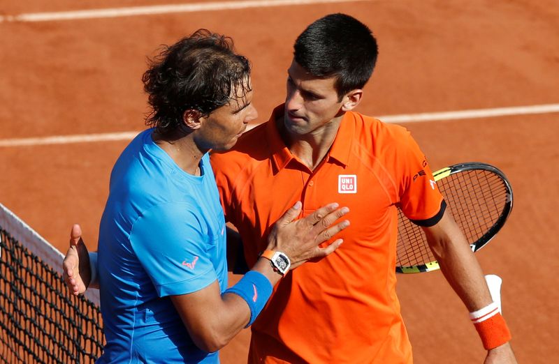FILE PHOTO: Novak Djokovic hugs Rafa Nadal following his 7-5 6-3 6-1 victory in the French Open quarter-finals at Roland Garros in Paris.