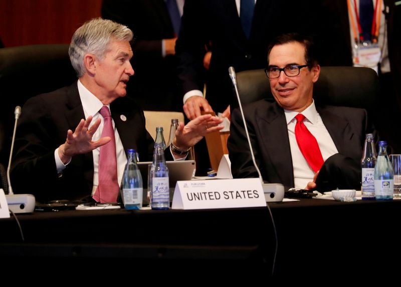 FILE PHOTO: Federal Reserve Chairman Jerome Powell talks with U.S. Treasury Secretary Steven Mnuchin during the G20 finance ministers and central bank governors meeting in Fukuoka
