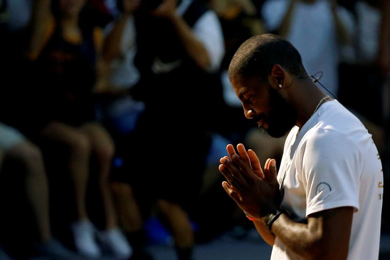 FILE PHOTO: NBA player Kyrie Irving of the Cleveland Cavaliers reacts during a promotional event in Taipei