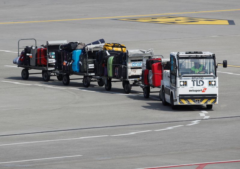 Luggage stored on trolleys is transported by air service provider Swissport at Zurich airport
