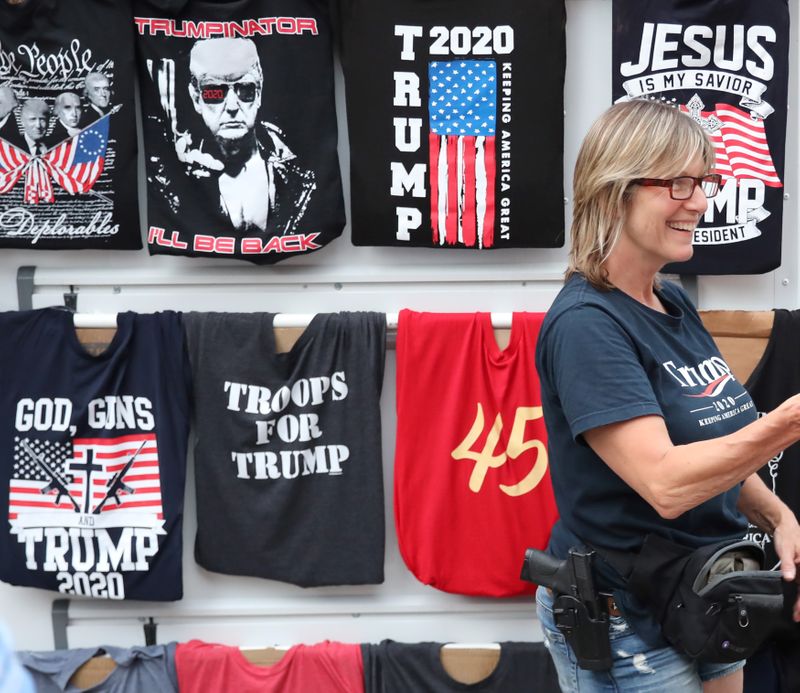 A woman sells T-shirts near the BOK Center in Tulsa