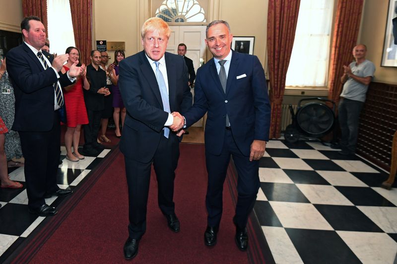 Britain's Prime Minister Boris Johnson shakes hands with Mark Sedwill in London