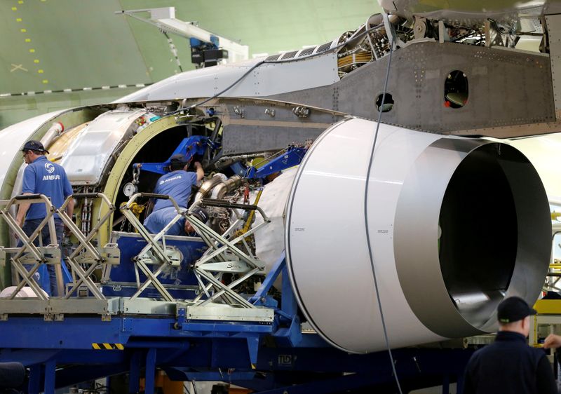 FILE PHOTO: Employees work on an engine of Airbus Beluga XL at the final assembly line at Airbus headquarters in Blagnac, near Toulouse