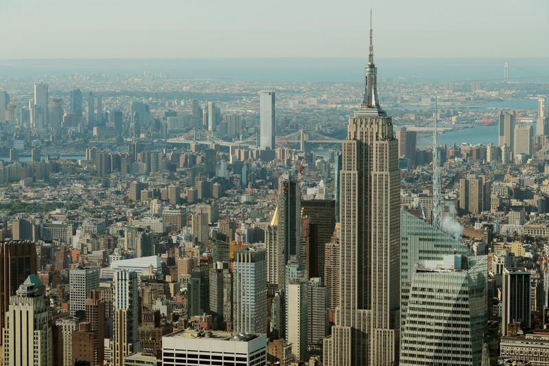 FILE PHOTO: The Empire State Building rises above Manhattan in front of the Brooklyn and Manhattan bridges as seen from an apartment in the Central Park Tower building as the building celebrates its topping out in New York
