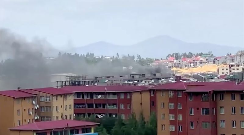 Smoke rises over Addis Ababa skyline during protests following the fatal shooting of the Ethiopian musician Haacaaluu Hundeessaa