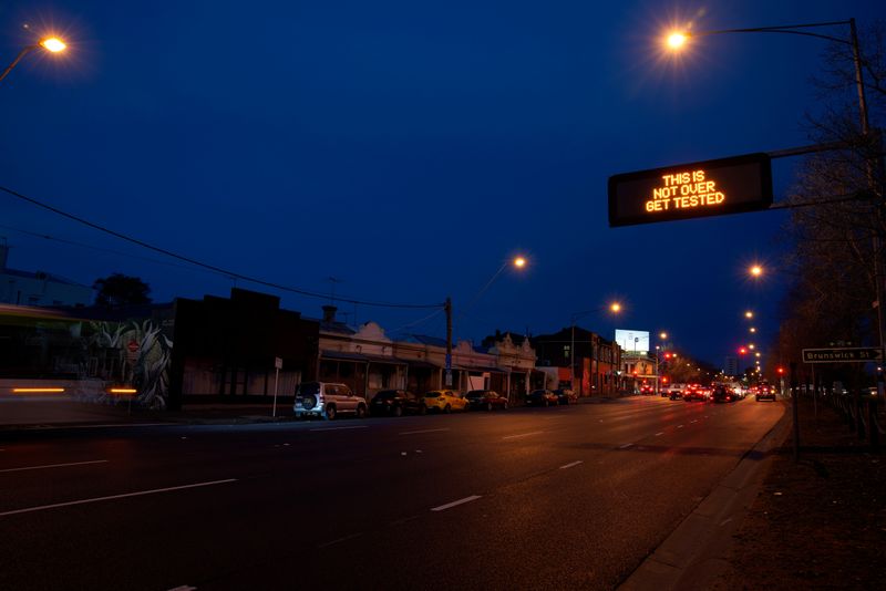 FILE PHOTO: A sign encouraging people to get tested is seen during COVID-19 lockdown restrictions in Melbourne