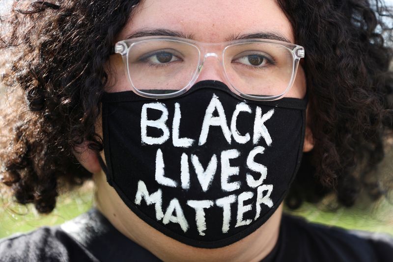 People demonstrate in solidarity with the Black Lives Matter (BLM) rallies in the United States, calling for an end to police brutality against Black people in the United States and First Nations people in Australia, in Sydney