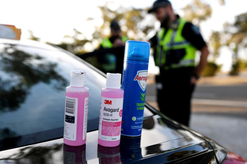 FILE PHOTO: Disinfectant products are seen on a car whilst motorists fill out paperwork for police as they cross back into South Australia from Victoria during the coronavirus disease (COVID-19) outbreak, in Bordertown
