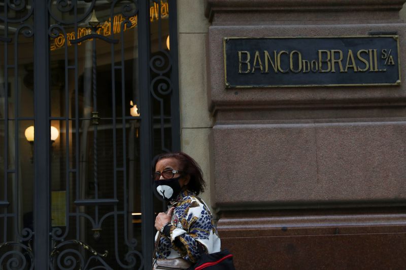 A woman wearing a protective face mask walks in front of Banco do Brasil (Bank of Brazil) cultural building during the coronavirus disease (COVID-19) outbreak, in Sao Paulo