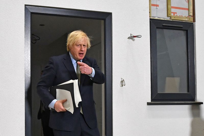 FILE PHOTO: Britain's Prime Minister Boris Johnson Britain's gestures after inspecting a modular house, after delivering a speech during his visit to Dudley College of Technology in Dudley
