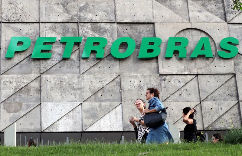 FILE PHOTO: People walk in front of the Brazil's state-run Petrobras oil company headquarters in Rio de Janeiro