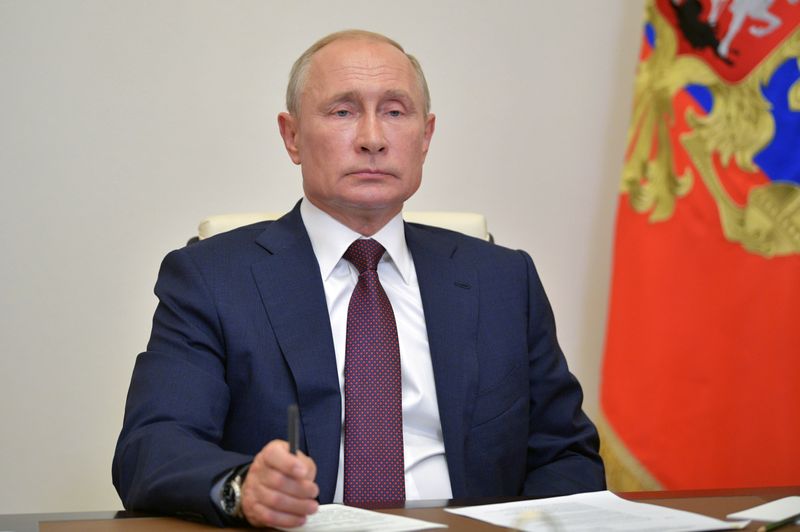 Russian President Vladimir Putin takes part in a a video conference call outside Moscow