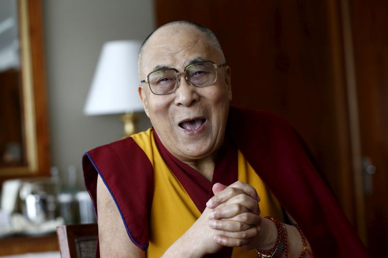 FILE PHOTO: Tibetan spiritual leader the Dalai Lama talks with journalists in Geneva