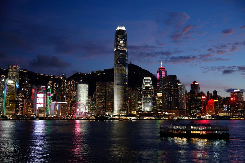 FILE PHOTO: A Star Ferry boat crosses Victoria Harbour in front of a skyline of buildings during sunset, as a meeting on national security legislation takes place in Hong Kong