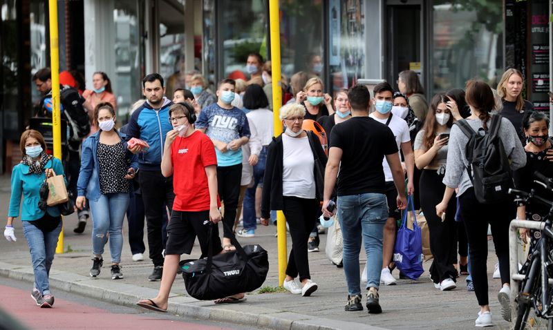 FILE PHOTO: People are seen at a public transport bus stop in Berlin