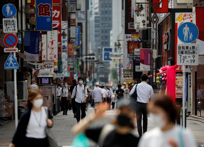 Passersby wearing protective face masks are seen on the street amid the coronavirus disease (COVID-19) outbreak, in Tokyo