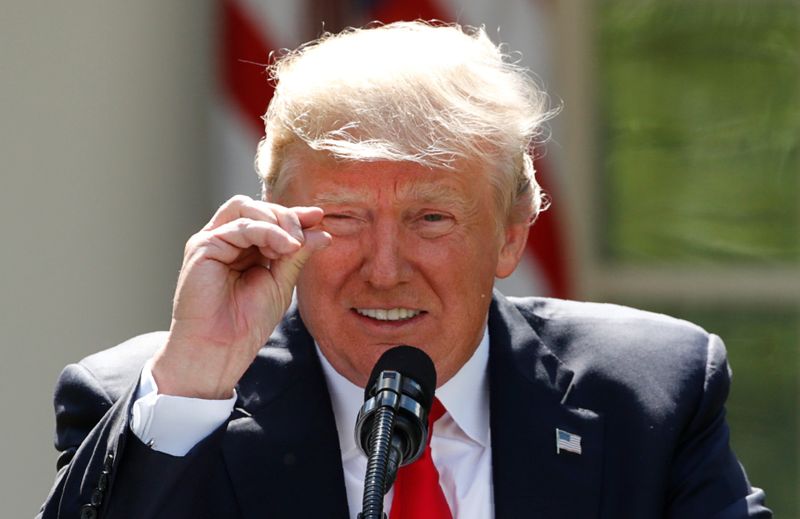 FILE PHOTO: U.S. President Trump refers to temperature change as he announces decision to withdraw from Paris Climate Agreement at White House in Washington