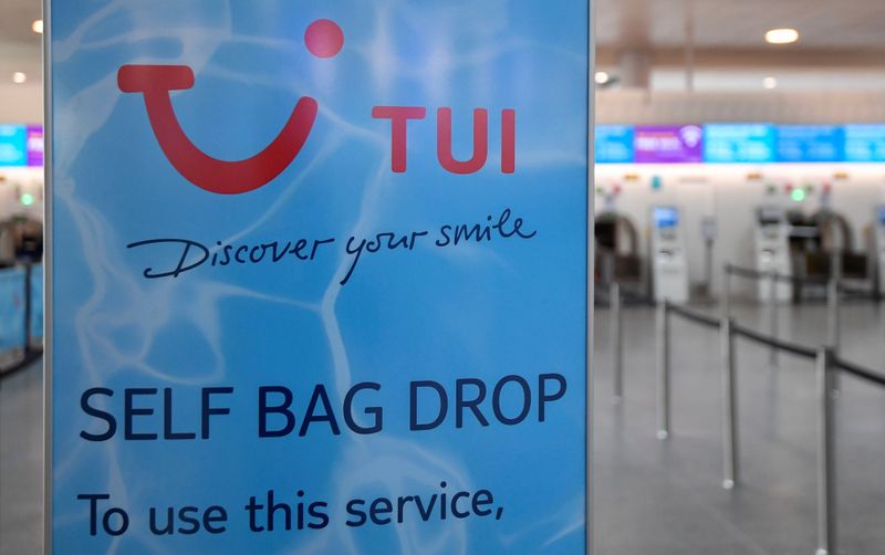 TUI sign is seen at the check-in area at Gatwick Airport, in Gatwick