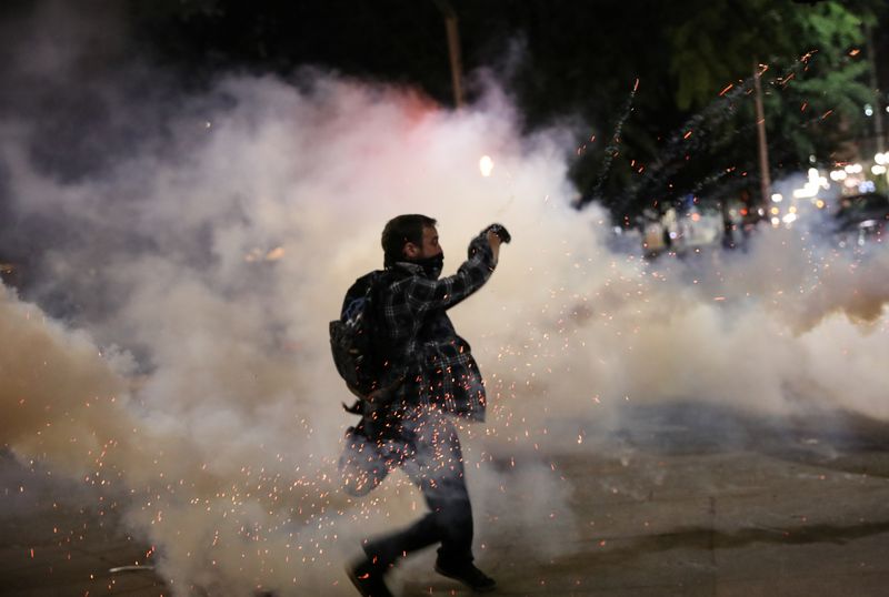 Federal law enforcement officers deployed under the Trump administration's new executive order face off with protesters