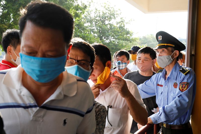 Soccer fans wearing protective masks while they enter for a soccer match between Viettel and Duoc Nam Dinh of the Vleague after the Government eased nationwide lockdown following the coronavirus disease (COVID-19) outbreak in Nam Dinh