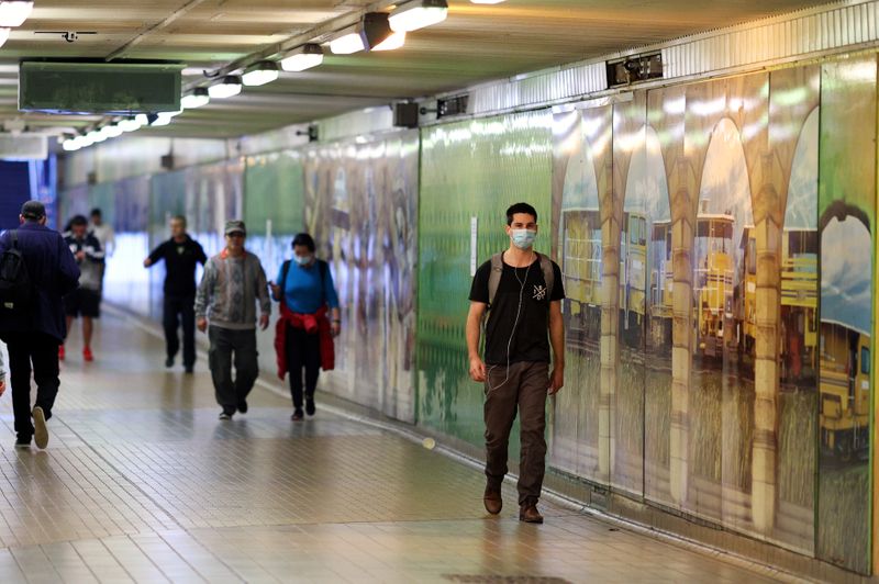 People walk through a tunnel in the city centre in Sydney