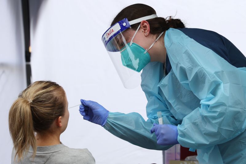 FILE PHOTO: A medical worker administers a test for COVID-19 on a member of the public in Sydney