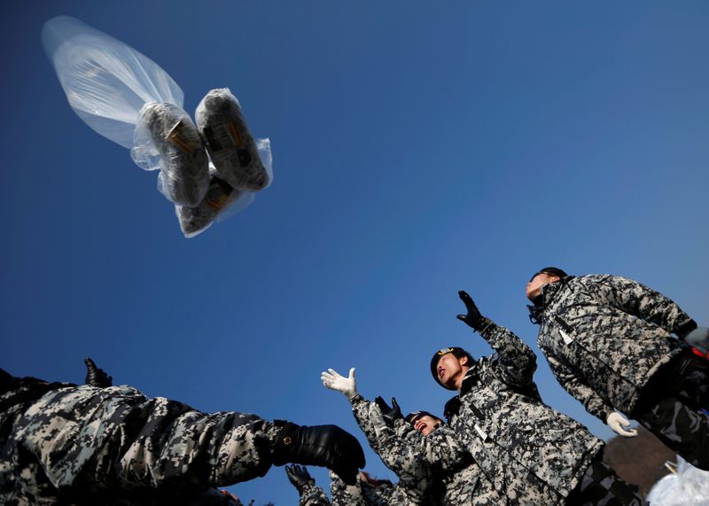 FILE PHOTO: Former North Korean defectors release a balloon containing one dollar banknotes, radios, CD and leaflets denouncing the North Korean regime towards the demilitarized zone, in Paju