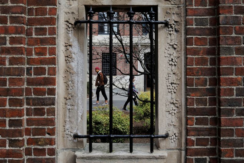 FILE PHOTO: Students and pedestrians walk through the Yard at Harvard University in Cambridge