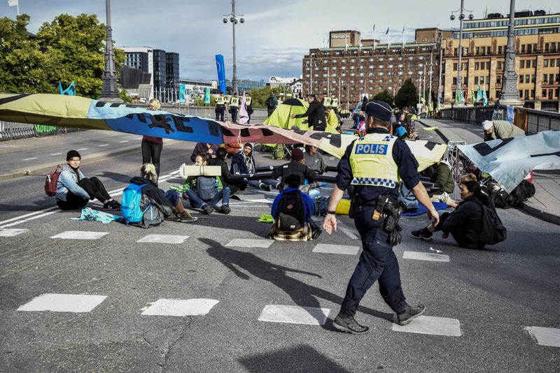 Climate change activists of Extinction Rebellion block the traffic at a bridge in central Stockholm