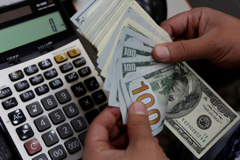 A money changer counts U.S. dollar banknotes at a currency exchange office in Diyarbakir