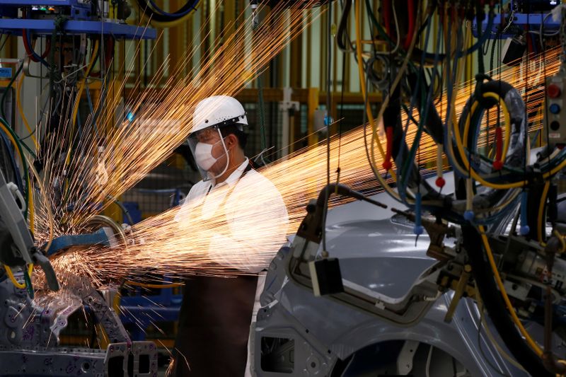 A man works in the automobile production line of the new Honda plant in Prachinburi