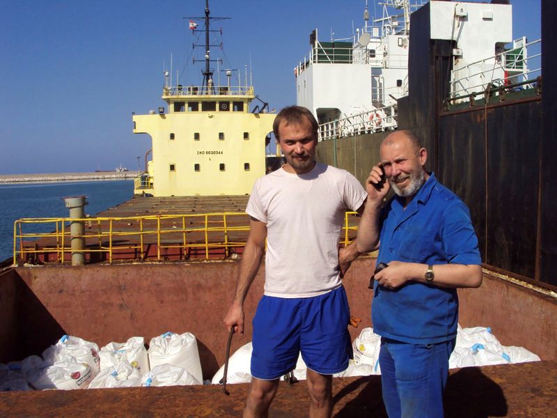 FILE PHOTO: Boris Prokoshev, captain of cargo vessel Rhosus, and boatswain Boris Musinchak pose next to a freight hold in Beirut