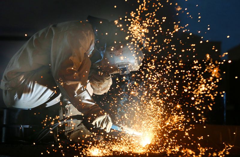 Worker works on a production line at a factory of a ship equipments manufacturer, in Nantong, Jiangsu