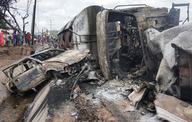 People inspect the damage at the site of a gas tanker explosion in the central Nigerian state of Kogi