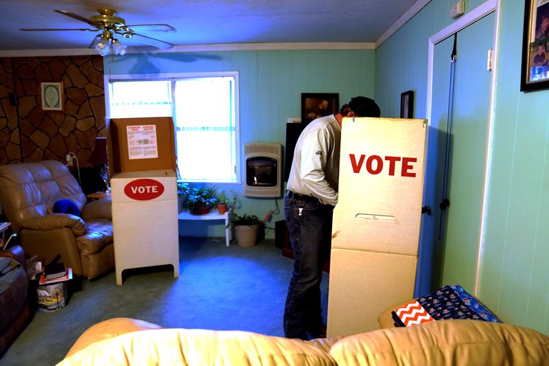 A voter fills out his ballot in Margaret Johnson's living room, which serves as voting place, on Super Tuesday in Allen
