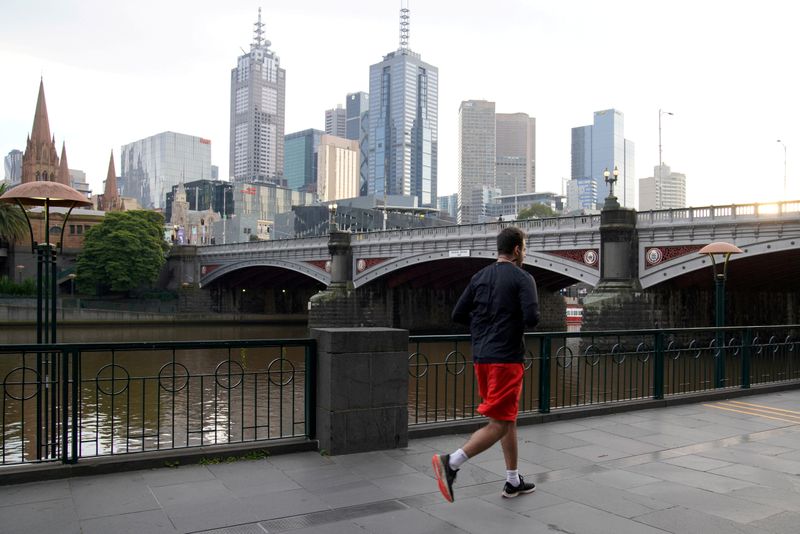 FILE PHOTO: A solitary man runs along a waterway under COVID-19 lockdown restrictions in Melbourne