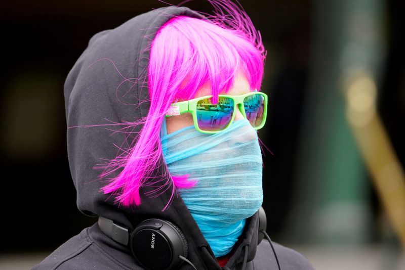FILE PHOTO: A person wears a scarf as a protective face mask in Melbourne, the first city in Australia to enforce mask-wearing to curb a resurgence of COVID-19