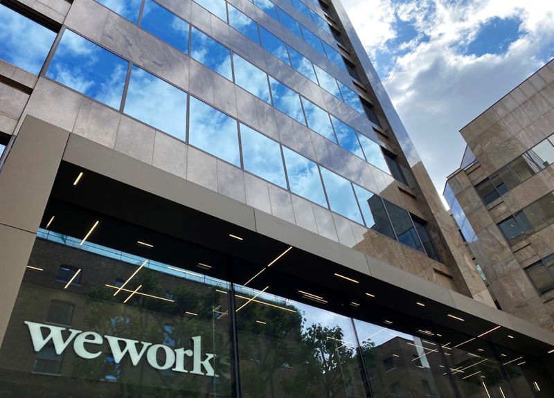 FILE PHOTO: The logo of WeWork is seen in the window of a building in London