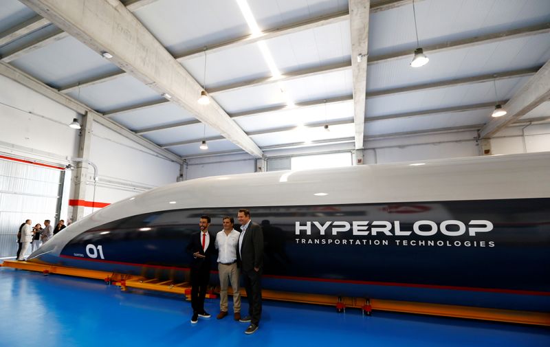 FILE PHOTO: Hyperloop TT co-founder and CEO, Dirk Ahlborn, Airtificial co-founder and chairman, Rafael Contreras and Hyperloop TT chairman and co-founder, Bibop Gresta pose next to the world's first full-scale passenger Hyperloop capsule during its present
