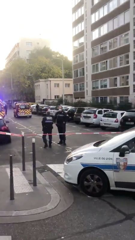 Police officers guard a scene where an Orthodox priest was shot and injured as the assailant fled, as police source claims, in Lyon
