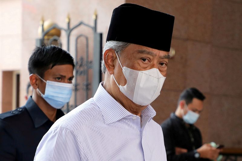 FILE PHOTO: Malaysia's Prime Minister Muhyiddin Yassin wearing a protective mask arrives at a mosque for prayers, amid the coronavirus disease (COVID-19) outbreak in Putrajaya